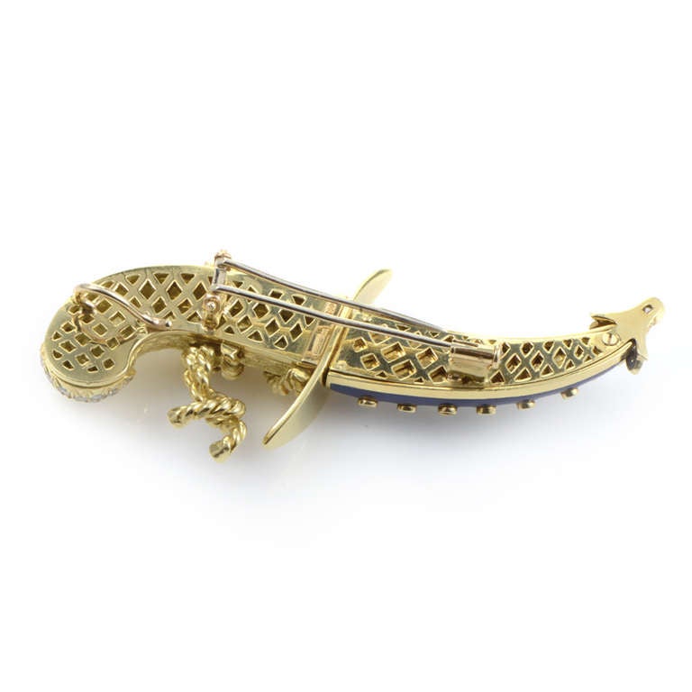 Exotic and rare, this brooch from Tiffany & Co. is absolutely stunning. The brooch is made of 18K yellow gold and is shaped like an Arabian scimitar. Lastly, the sword's sheath is made of a brilliant blue enamel studded with ~1.50ct of diamonds.