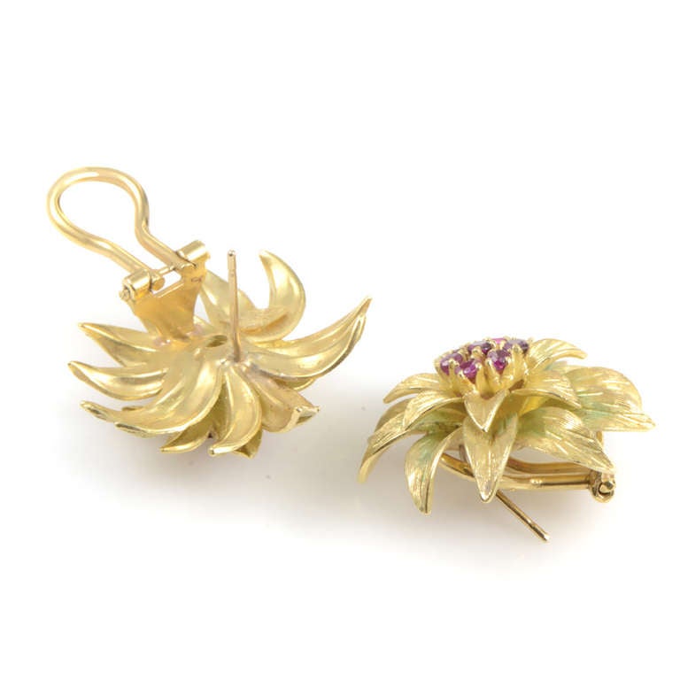 Intricately designed, and absolutely stunning, this pair of earrings from Tiffany & Co. is perfect for a fashion-forward lady. The earrings are made of 18K yellow gold and have centers set with .60ct of red rubies.