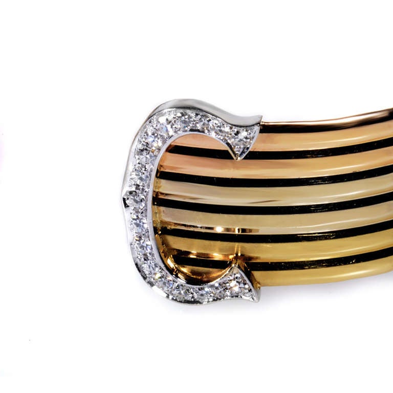 Three shades of gold come together in harmony to make this gorgeous bangle bracelet from Cartier. The bracelet is made primarily of varying shades of 18K rose and white gold. Lastly, the ends of the bangle are capped off with diamond-set white gold