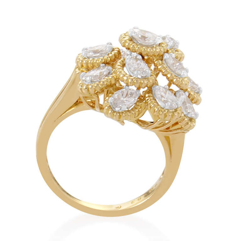 This dazzling cocktail ring from Oscar Heyman is truly stunning with its burnished gold and sumptuous diamonds. The ring is made of 18K yellow gold and looks like a flower with lovely diamond-set petals.

Ring Size: 6.75 (53 3/8)
Diamond Carat