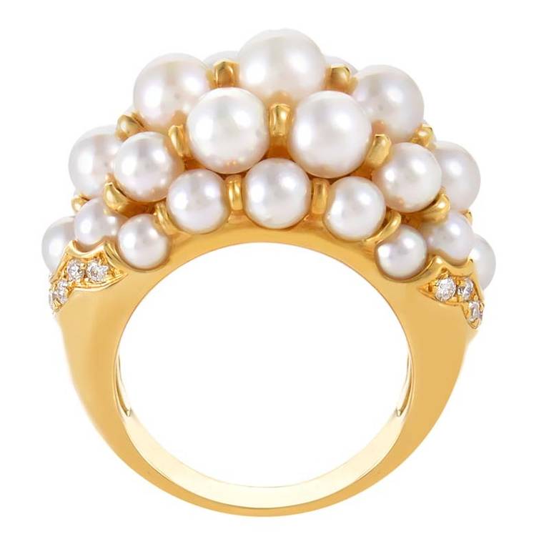 This festively designed ring from Cartier is sumptuous and distinct. The ring is made of 18K yellow gold and is set with white pearls and ~.35ct of diamonds.
Ring Size: 6.0 (51 1/2)
Included Items: Manufacturer's Box