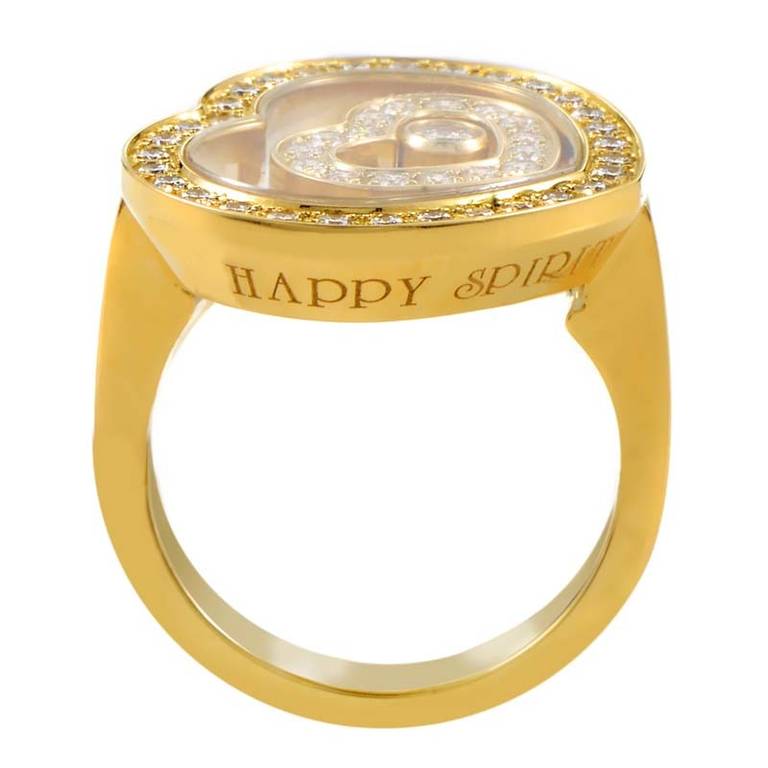 A romantic and whimsical design from Chopard's Happy Spirit Collection; the 18K Yellow Gold Diamond Set Heart Ring. The ring features a heart-shaped motif set with diamonds and an exhibition window that displays another heart as well as a single