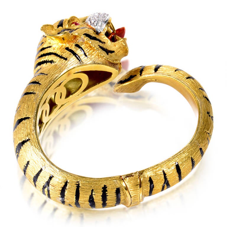 The perfect statement piece; this vintage bangle bracelet is truly a work of art. The bracelet is made of 18K yellow gold and depicts a tiger baring its sharp teeth. Its muzzle is made of white gold and is set with ~.45ct of diamonds. Lastly, the