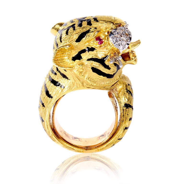 This fiercely fabulous piece of vintage jewelry is perfect for the woman who dares to be different! The ring is made of 18K yellow gold and depicts a tiger baring its sharp teeth. Its muzzle is made of white gold and is set with ~.15ct of diamonds.