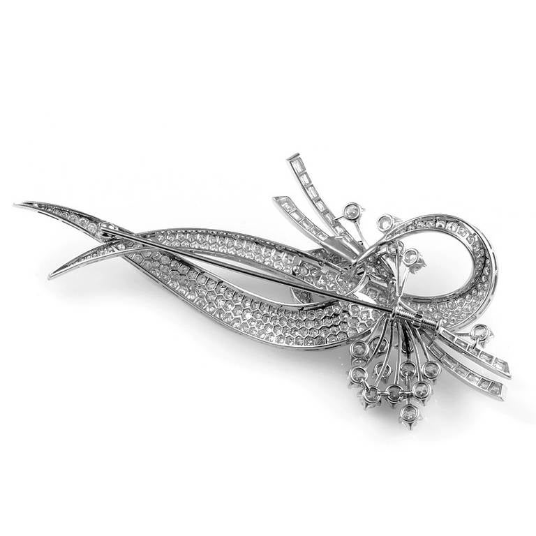 Feast your eyes upon the sumptuous design of this diamond encrusted brooch! This over sized piece of statement jewelry is made of platinum and is set with ~7.96ct of round brilliant and diamond baguettes.