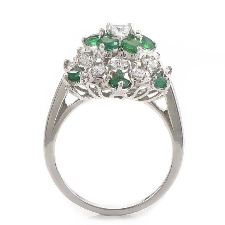This custom designed precious gemstone ring from Oscar Heyman is without comparison! The ring is made of platinum and is set with a cluster of white diamonds and ~1.10ct of emeralds.

Ring Size: 5.75 (50 7/8)
Diamond Carat Weight: 0.75