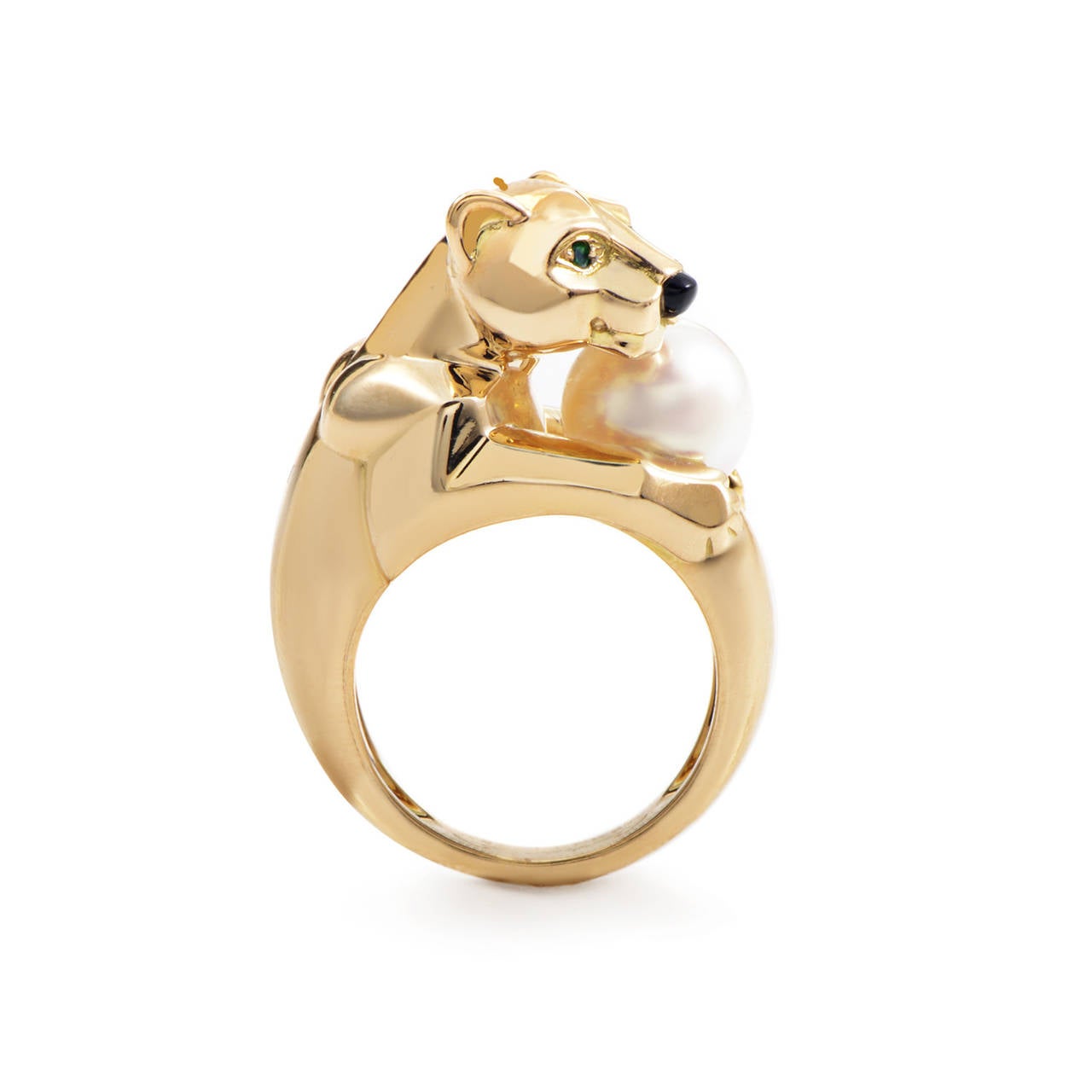 The Cartier Panthere collection is well known for its bold design that all feature panther motifs. The ring is made of 18K yellow gold and boasts a panther-shaped motif with green emerald eyes, an onyx nose, and a pearl clutched in its
