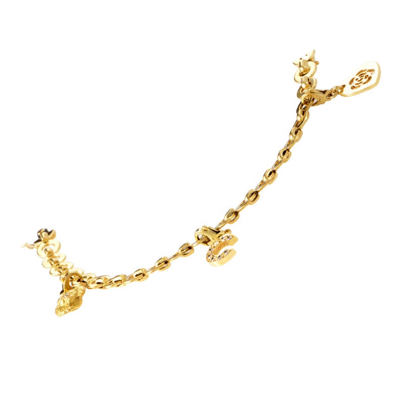 This adorable charm bracelet from Chanel boasts motifs that perfectly represent the brand. The bracelet is made of 18K yellow gold and boasts three charms that represent iconic Chanel symbols; the Camélia flower and a lion, Coco Chanel's zodiac