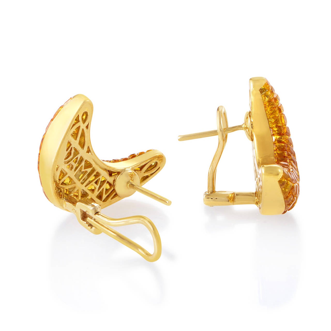 Boasting pleasant unconventional form these eye-catching earrings designed by Damiani offer stylish cheery appearance; the pair is made of radiant 18K yellow gold marvelously combined with attractive yellow sapphires weighing 7.00 carats in total.