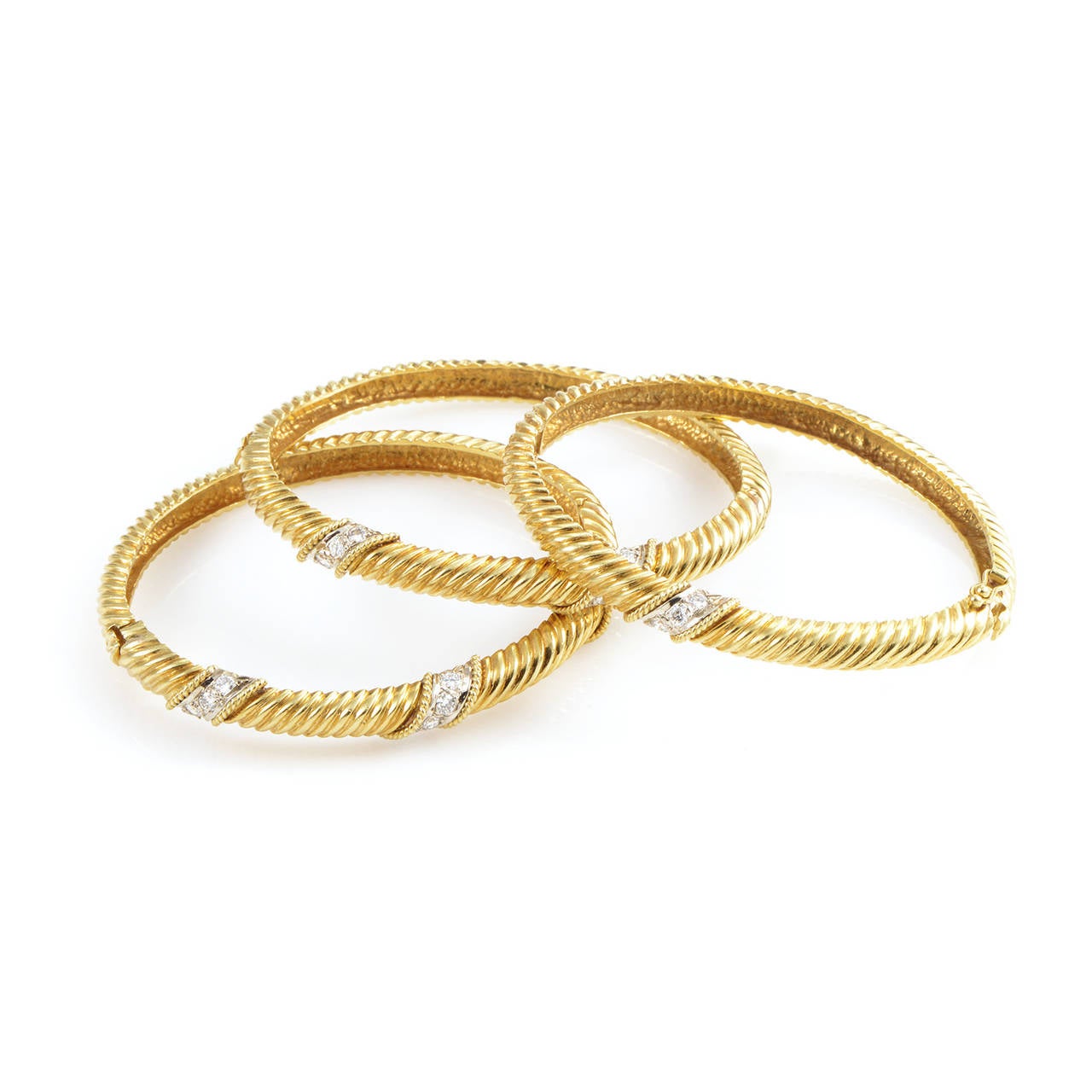 A twinkling set of bangles is one of the most stylish accessories out there. This set of bangles is made from pure 18K yellow gold and are set with 1.90 carats of shimmering diamonds.