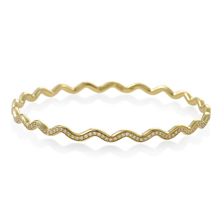 Light as a feather, and brilliant as the sun, this bangle bracelet from Tiffany & Co.'s Paloma Picasso collection is a real stunner! The bracelet is made of 18K yellow gold and boasts a zigzag design set with diamonds.

Diamond Carat Weight: 2.00