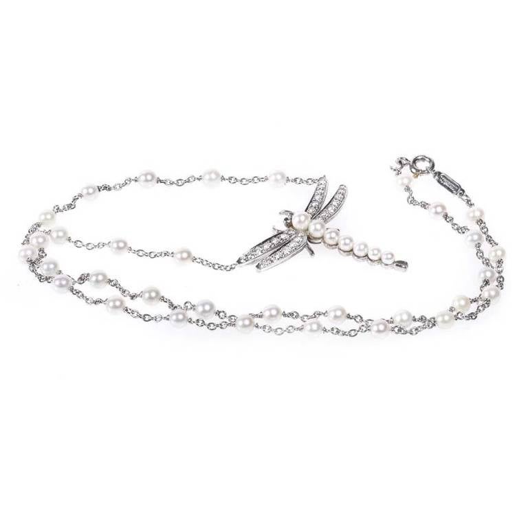 Tiffany & Co. created a true masterpiece when they designed this exceptional pendant necklace. The necklace is made of platinum studded with diamonds. Hanging from the necklace is a dragonfly shaped pendant set with diamonds and pearls. Lastly, the
