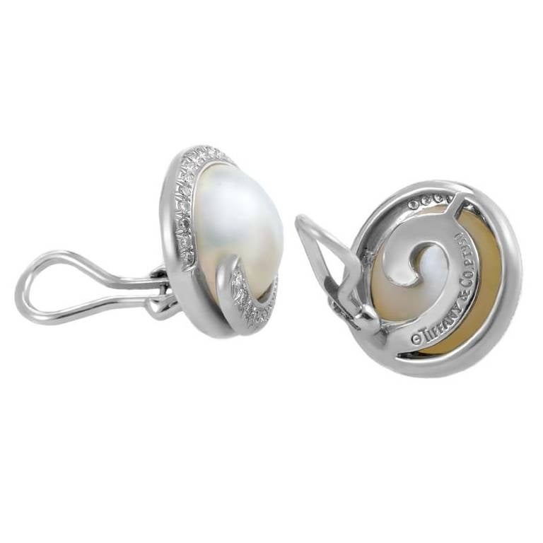 This classically designed pair of clip-on earrings from Tiffany & Co. boasts an air of refinement and sophistication. The earrings are made of platinum and are each set with a mabe pearl encircled by ~.85ct of diamonds.