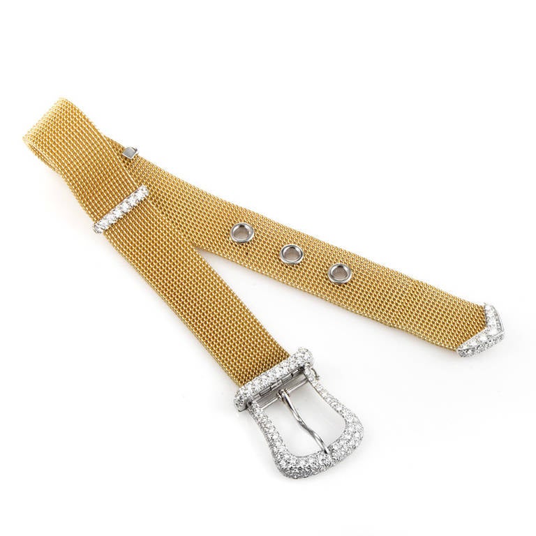 Boldly designed and very unique, this belt bracelet from Tiffany & Co. is sure to please! The bracelet is made of 18K yellow gold mesh and is accented with a platinum buckle and holes. Lastly, the buckle and end of the strap is accented with a