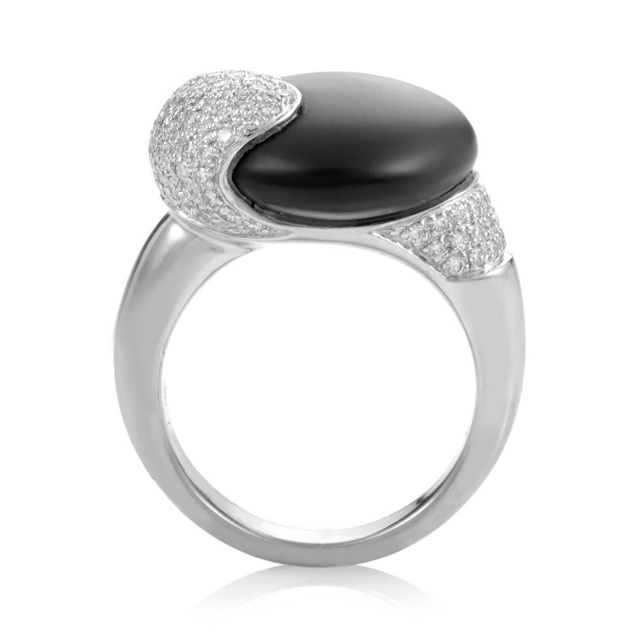 This lovely ring from Movado is quite unique due to the inclusion of different kinds of materials. The ring is made of 18K white gold and boasts shanks set with a partial pave of diamonds. Lastly, a smooth black stone adds a unique touch to the