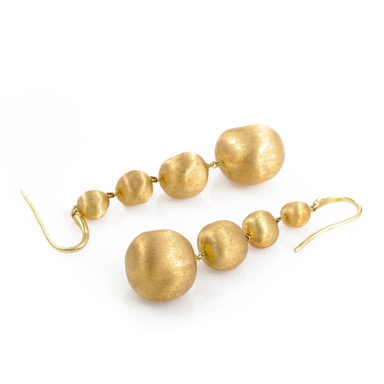 Golden and gorgeous, this pair of earrings from Marco Bicego's Africa Collection have a decadent design that is quite lovely. The earrings are made of solid 18K yellow gold, and each earring features four brushed yellow gold spherical