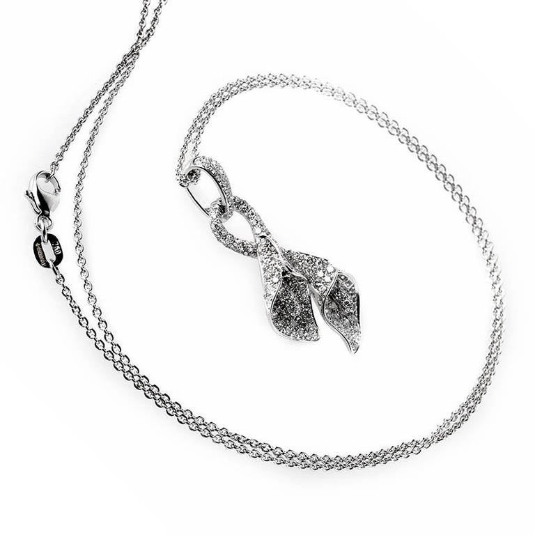 This pendant necklace from Asprey is gorgeous and feminine. It is made of 18K white gold and boasts a pendant that depicts two entwined calla lilies. The pendant has a gorgeous ~1.51ct diamond pave.
Approximate Dimensions: Drop of the Necklace: