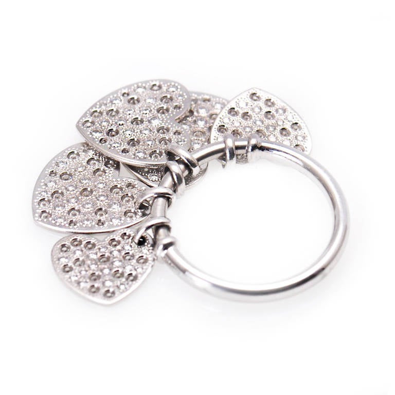 Amazing dangle ring from Dior in 18K white gold and set with ~1.55ct of pave diamonds. Femininity and fashion are all elements in the design - the narrow band has two tiny ridges to prevent the five dangling diamond-set hearts from moving all the
