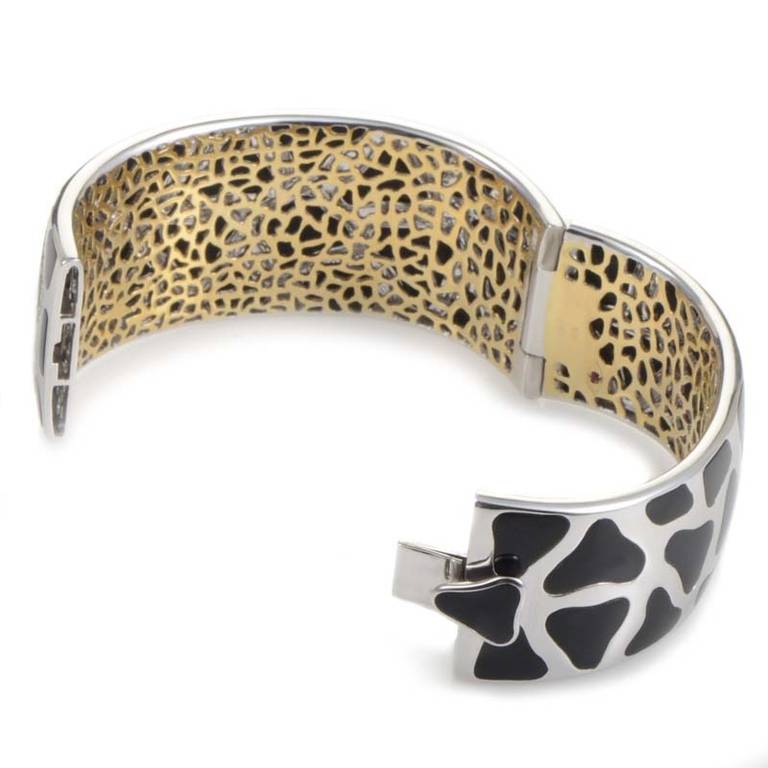 Always innovative, Roberto Coin played upon the fashionable style of animal-print and paid homage to an animal that is rarely used in fashion; the Panda! This bracelet is made of 18K white gold with a yellow gold interior accented with a single