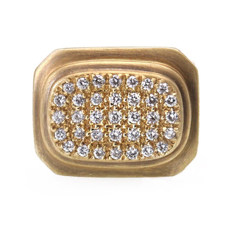 The designs from the Slane sisters are always fresh and trendy. This 18K yellow gold ring has all the elements one has come to expect - brushed matte gold has a wide shank with ridges to add interest. The high setting looks almost Greek in