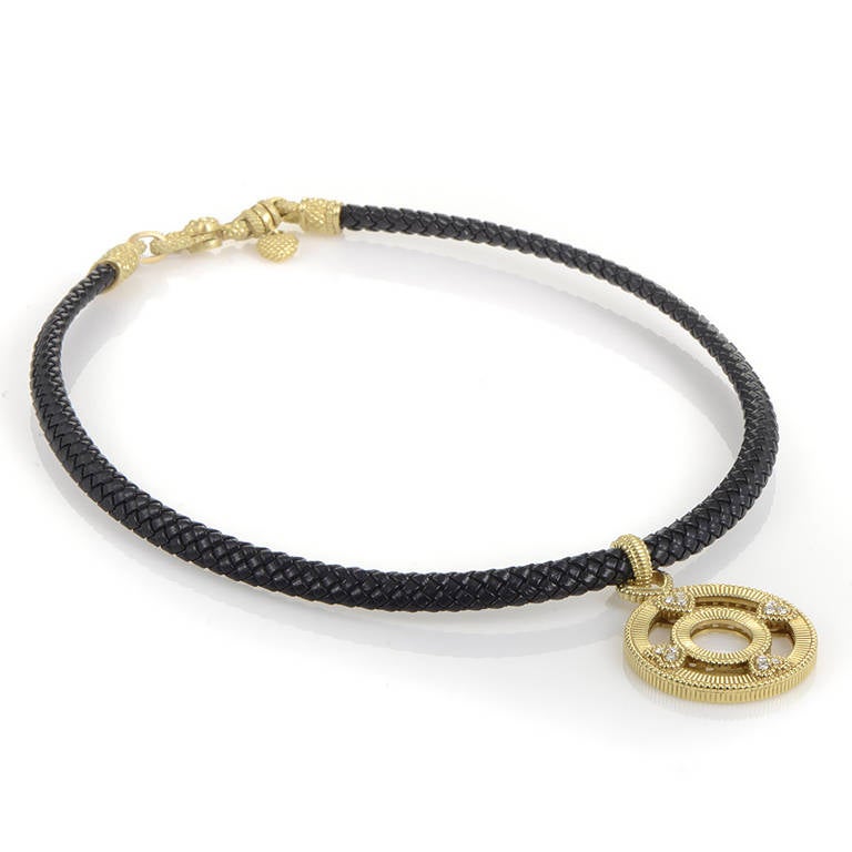 This one of a kind piece from Judith Ripka has a fashionable design that finely crafted to perfection. The necklace is a black leather cord from which hangs an openwork 18K yellow gold pendant. Lastly, the pendant boasts four heart-shaped motifs set