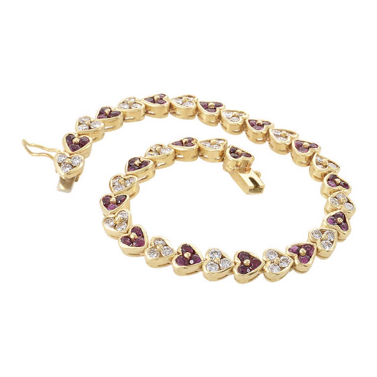The beauty of this bracelet from Repossi transcends time and is sure to be treasured for a lifetime. The bracelet is made of 18K yellow gold and is comprised of heart-shaped motifs. The hearts are set with ~2.75ct of diamonds and ~2.49ct of rubies.