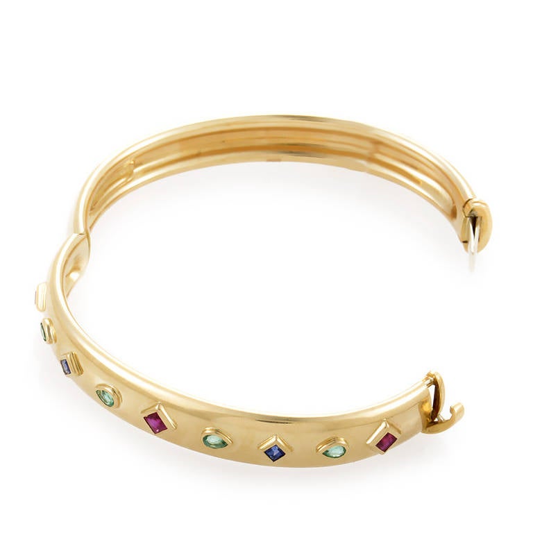 Adorn yourself with luxury as you don this gorgeous bangle bracelet from Cartier. The bracelet is made of 18K yellow gold and is studded with two diamond-shaped sapphires, four pear-shaped emeralds, and three diamond-shaped rubies.
Included Items: