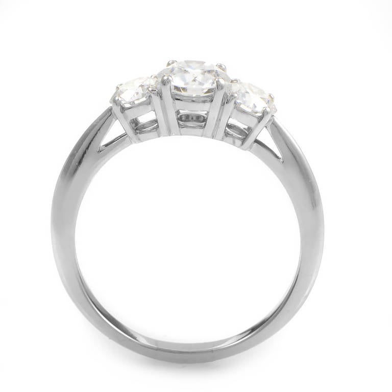 The sheer brilliance of a Tiffany & Co. diamond engagement ring is without comparison. This ring is made of platinum and boasts an ~.75ct D color VVS1 diamond center stone flanked by ~.74ctw of D color VVS2 clarity diamond side-stones. All of the
