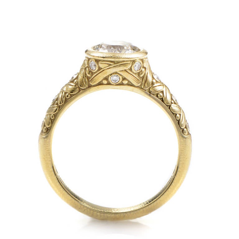 Intricate detailing and exceptional brilliance are the first thing that will catch your eye as you gain upon the dazzling design of this engagement ring from Alex Sepkus. The ring is made of carved 18K yellow gold and features shanks partially set