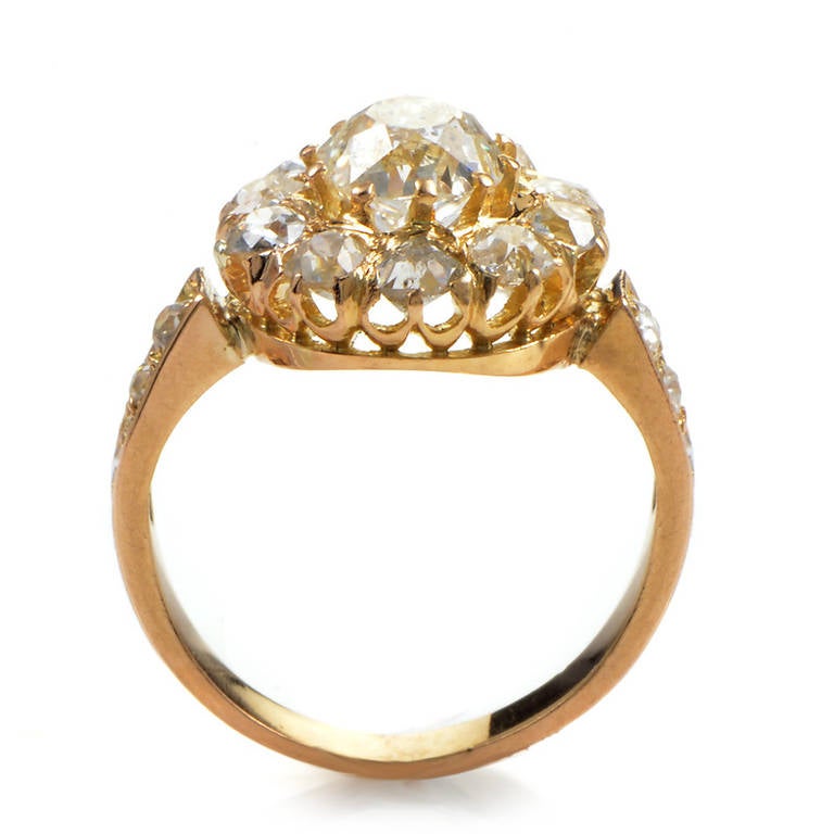 Edwardian jewelry is famous for its quintessential femininity and delicate motifs. This Edwardian ring is made of 18K yellow gold and features an ~1ct diamond main stone surrounded by a halo of white diamonds. Lastly, the shanks are also set with