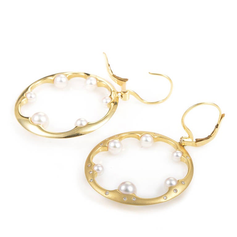 Prepare to be blown away by the absolutely stunning design of this lavish pair of dangling earrings from Mikimoto! The earrings are made of brushed 18K yellow gold and are studded with white diamonds. Lastly, inside of each of the uniquely designed