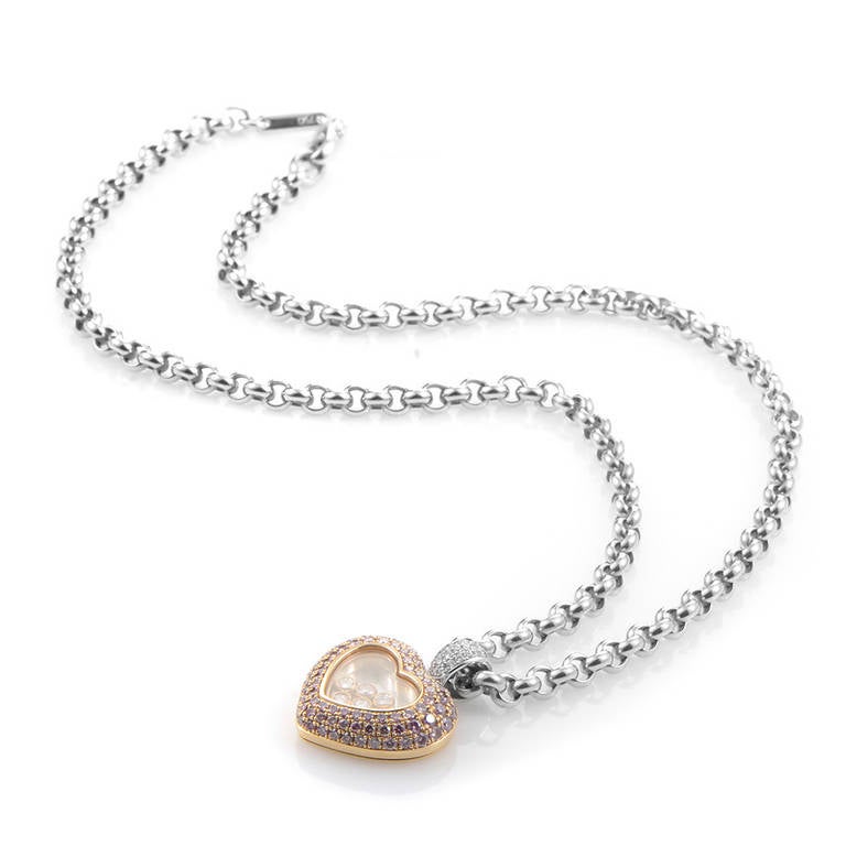 This ultra-feminine pendant necklace from Chopard's Happy Diamonds collection is sure to take your breath away! The necklace is made of 18K white gold and boasts a rose gold pendant with a diamond-set white gold pendant bail. The heart is paved with
