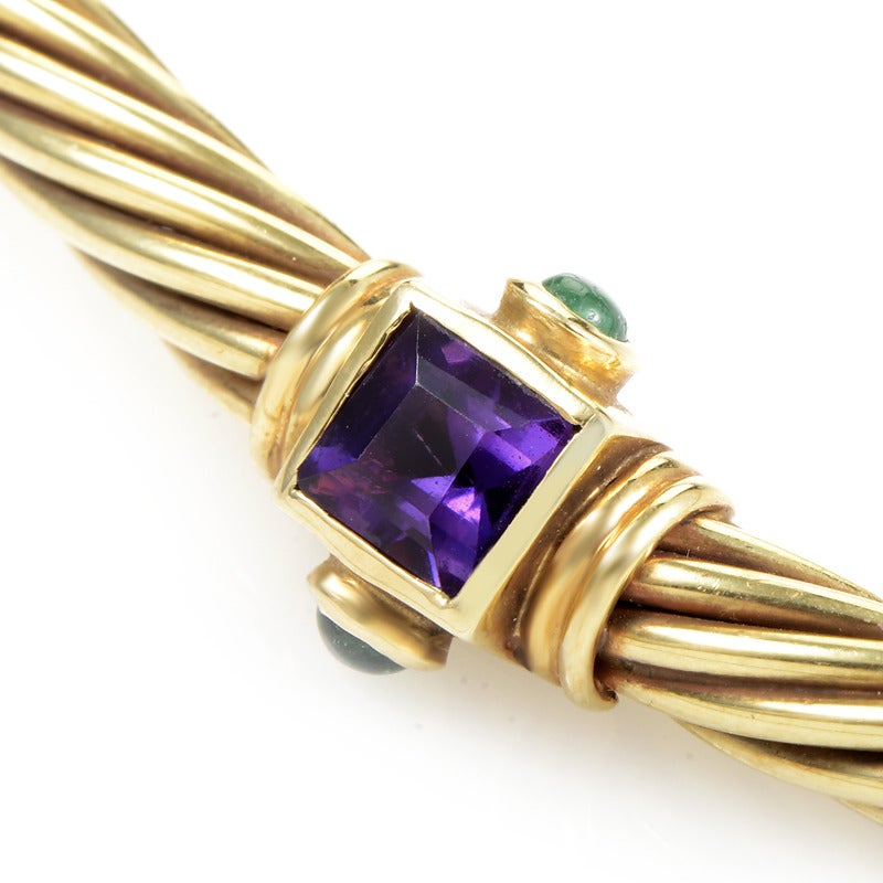 David Yurman is renowned for his jewelry's casual yet sophisticated look that always exudes an air of excellence. This collar necklace from the brand is made of 14K yellow gold and features a faceted amethyst stone flanked by two emerald cabochons.