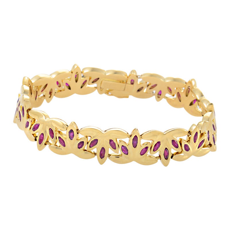 Chaumet delivers a succinct length of refined class in which to wrap your wrist. A leaf motif artfully shaped and perpetuated in 18K yellow gold plays host to the timeless allure of rubies.