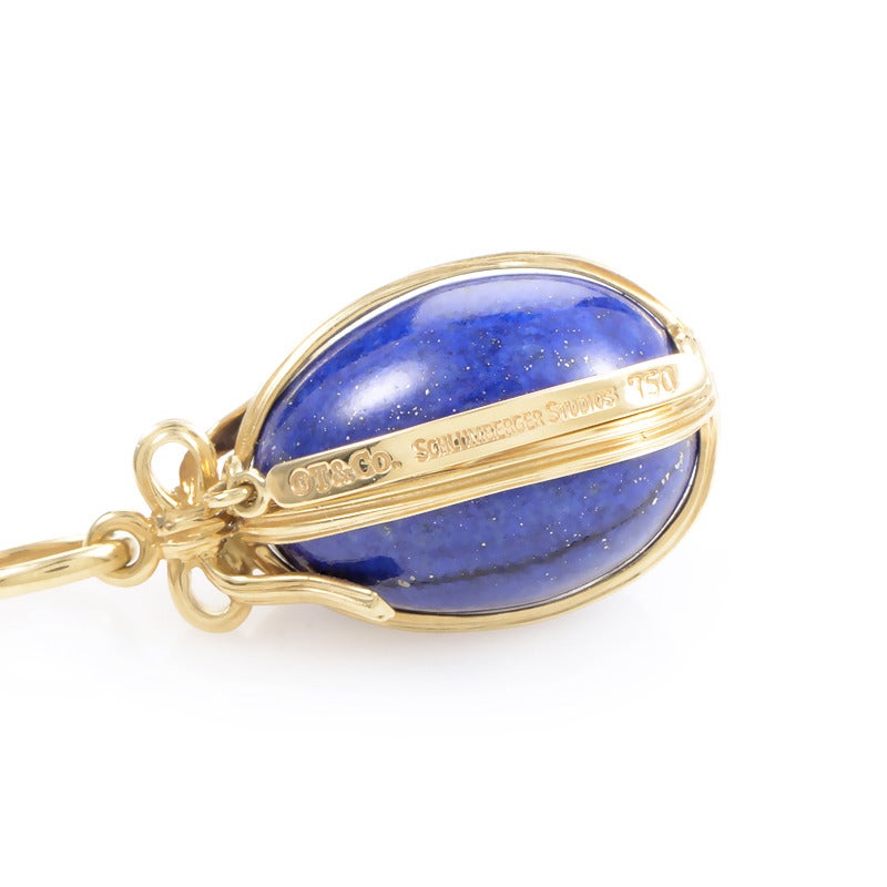 Famed jeweler Jean Schlumberger and Tiffany & Co. teamed up to make an exceptional line of jewelry that has become popular world wide. This pendant from the famous collaboration is made of 18K yellow gold and features a lapis lazuli egg pendant very