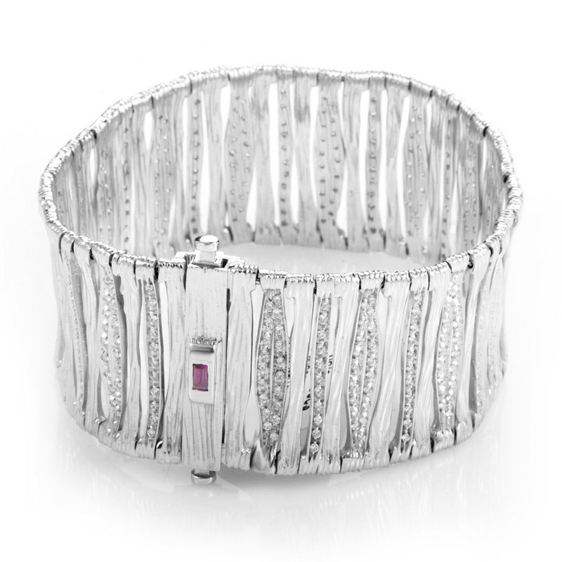 This flexible bracelet in 18K white gold and diamonds is from the Roberto Coin Elefantino Collection. The collection received its name due to the unique strips of elephant-like gold in it's filigreed, textured design. Lastly, the strips flex along a