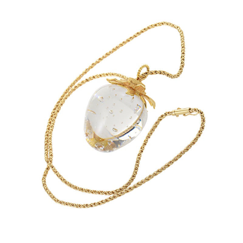 The playful design of this pendant necklace from Steuben cannot be ignored! The necklace is made of 14K yellow gold and a features a very distinct strawberry-shaped pendant. The pendant is made of lead crystal and is even accented with yellow gold