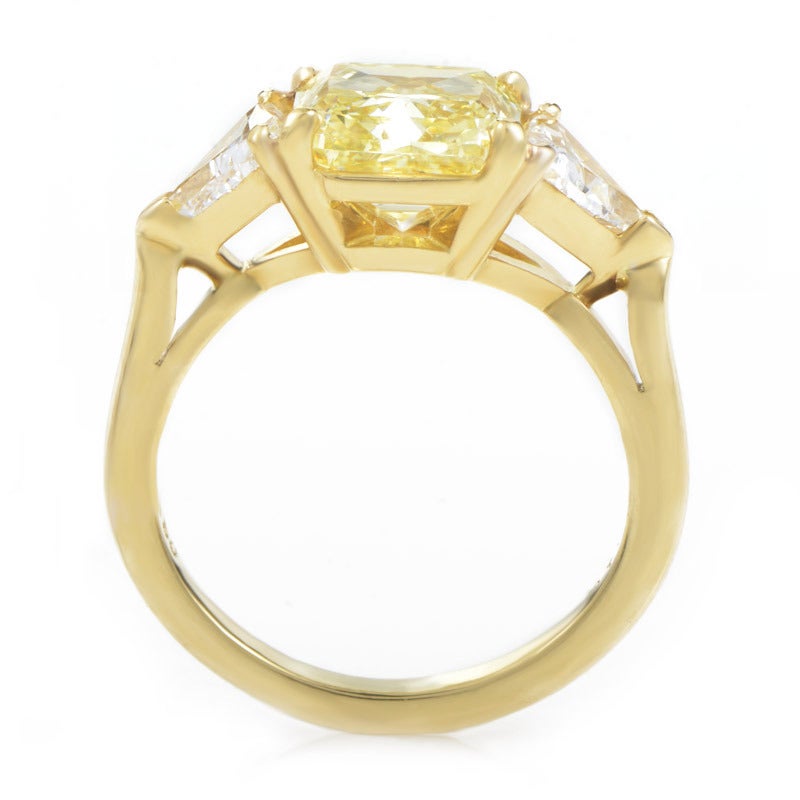 The ultimate status symbol every woman dreams of- an engagement ring from Tiffany & Co. This engagement ring is absolutely stunning with the rich golden glow of its 18K yellow gold band, and the shine that exudes from its top-quality diamonds. The