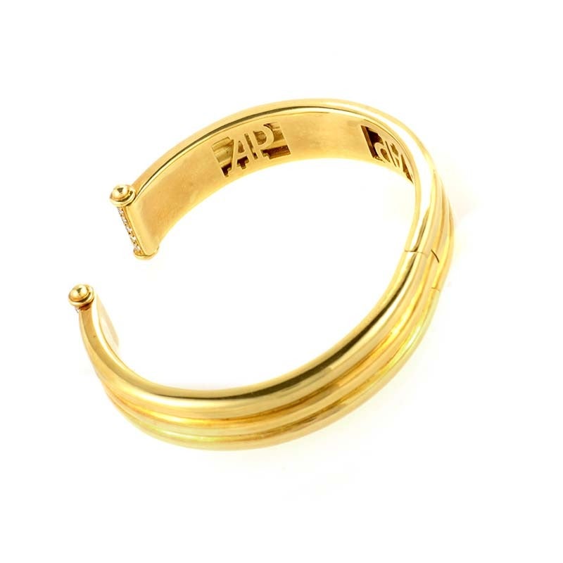 This bangle bracelet from Audemars Piguet is a rare find due to the fact that the company primarily produces luxury timepieces. The bangle is made of 18K yellow gold and each end is accented with a sprinkling of diamonds.