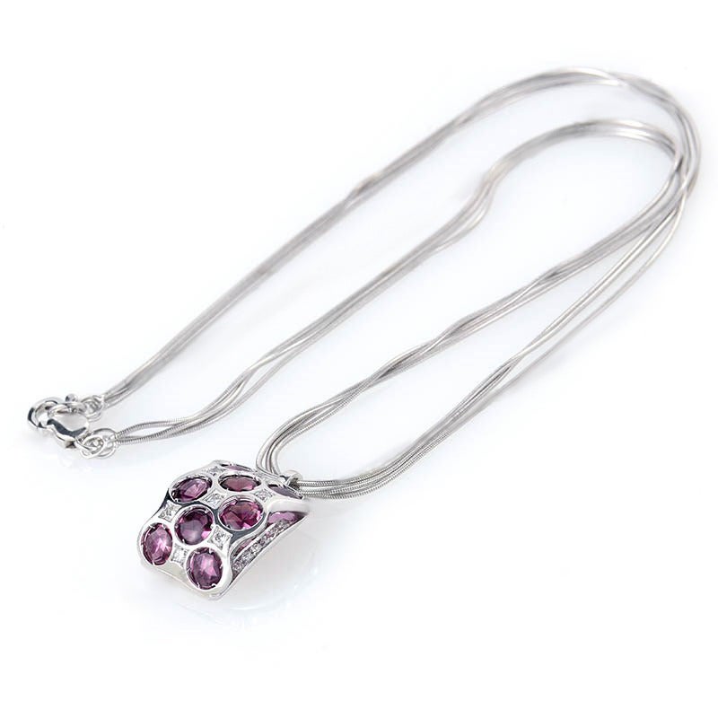 This pendant necklace from Bibigi is unique and shines with colorful gemstones. The pendant necklace is made of 18K white gold and boasts a pendant set with purple colored tourmaline stones and ~.50ct of diamonds.
Approximate Dimensions: Drop of