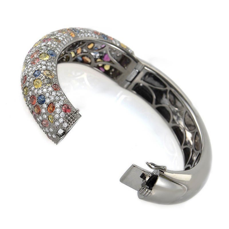 This bangle is magnificent and sparkles with various gemstones. The bracelet is made of rhodium-treated 18K white gold and set with a remarkable ~19.79ct of numerous colored sapphires accented with ~5.71ct of diamonds.
Retail Price: $35,088.00