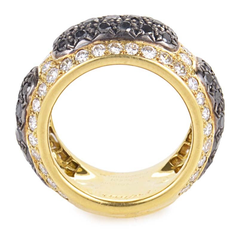 This fabulous band ring from de Grisogono shimmers with a fantastic diamond pave of multi-colored diamonds. The ring is made of 18K yellow gold and is set primarily with black diamonds and accented with white diamonds.
Ring Size: 6.5 (52