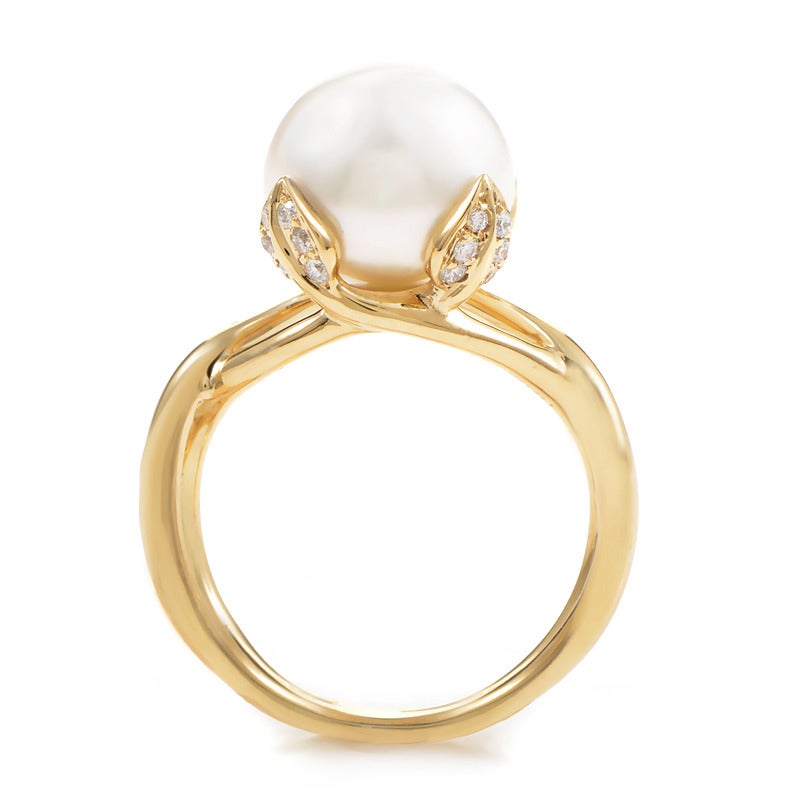 The simplicity of this Tiffany & Co. design really allows the true beauty of the pearl to stand out. The setting is made of 18K yellow gold and features leaf-like prongs set with diamonds. Lastly, the ring's main attraction is the large, white pearl