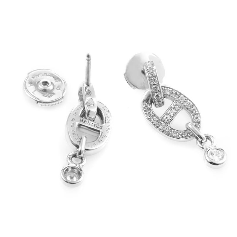 This dazzling pair of earrings from Hermes are perfect for everyday wear despite being completely set with diamonds. The earrings are made of diamond-set 18K white gold in the typical Chaine d'Ancre design. Lastly, a single diamond dangles from the