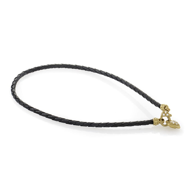 This one of a kind piece from Judith Ripka has a fashionable design that finely crafted to perfection. The necklace is a black leather cord from which hangs an 18K yellow gold heart-shaped pendant set with a glittering diamond pave.
Approximate