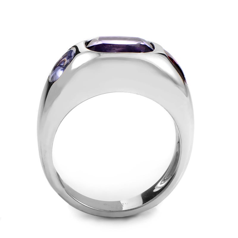 Flawlessly forged 18K white gold presents a worthy platform for multiple stones. Amethyst, tourmaline and iolite make bold statements at the crest of this ring's smooth taper.

Ring Size: 7.0 (54)
