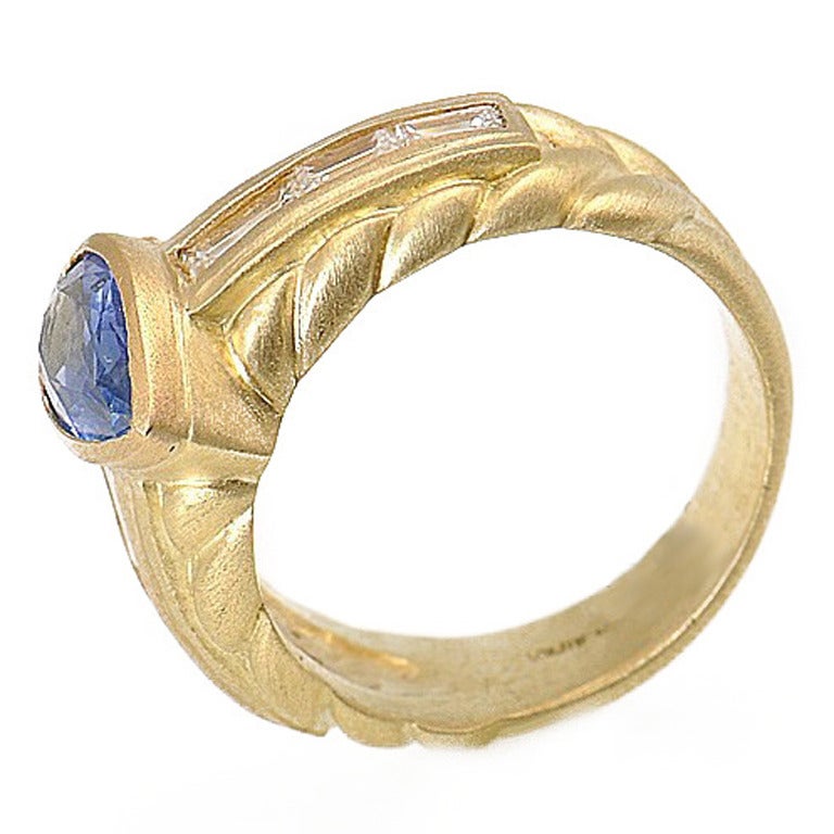 Judith Ripka - her jewelry always reflects her passion for fine jewelry, as well as reflecting her ability to give each piece it's unique individualism. This is a stunning 18K yellow gold and sapphire ring.Complimenting the pear shaped sapphire are