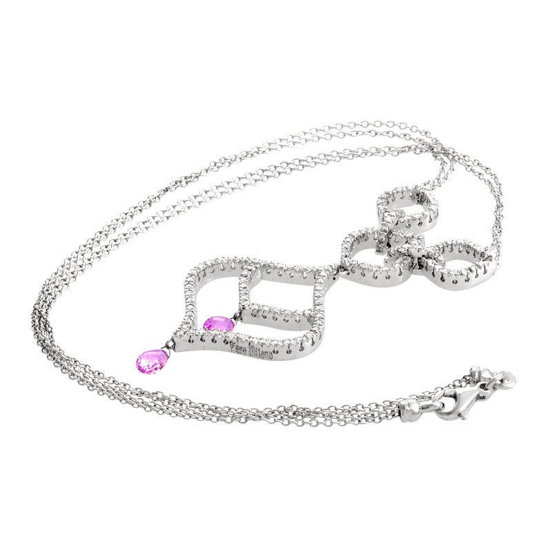 Feminine and fabulous, this pendant necklace from Piero Milano is an absolute delight to behold! The necklace is made of 18K white gold and features a large, openwork pendant set with diamonds. Lastly,~1.52ct of pink sapphires dangle from the