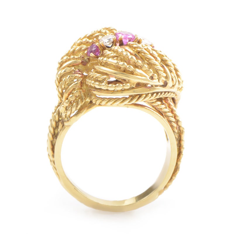 Strands of 18K yellow gold rope rise and twist into a textured cushion for luxury in this ring from Tiffany. The top the ring rolls into itself to float a compelling raft of 0.25ct rubies and 0.15ct diamonds.
Ring Size: 6.25 (52 1/8)