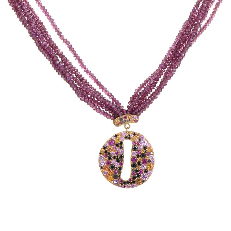 A bold design boasting multiple precious stones serves as a fine example of the Vasari magic. Rich strands of almandine garnet drop into the dense spectacle of 6.00ct of sapphires and 1.45ct of diamonds sparkling on the 18K yellow gold pendant.